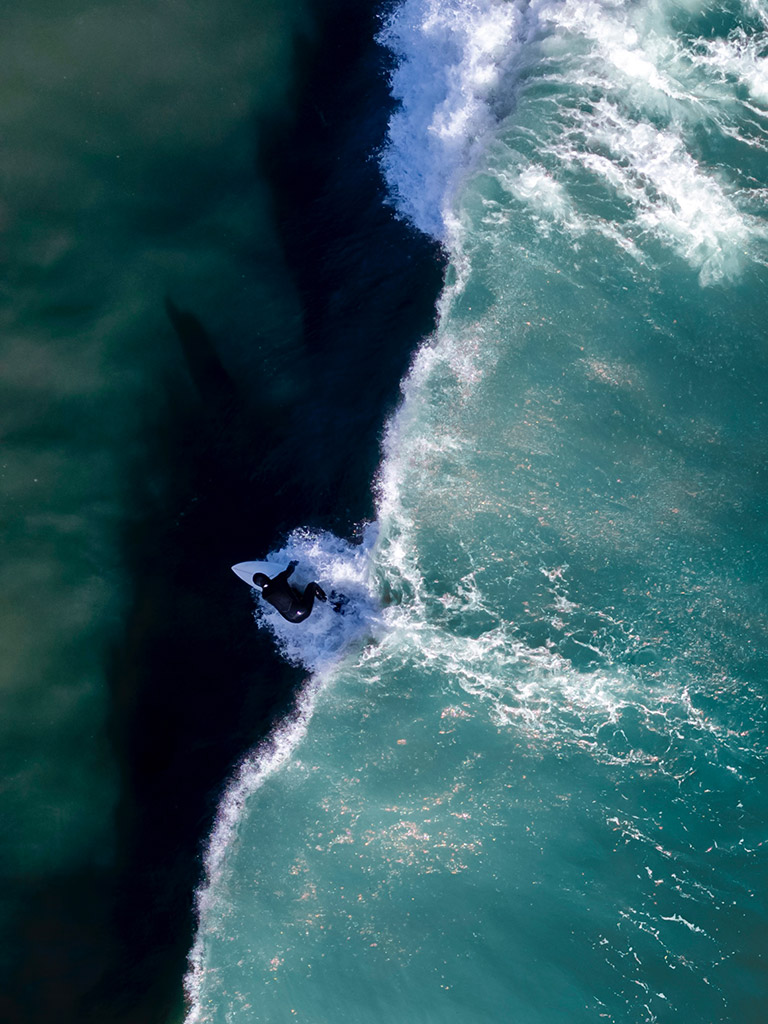 shades of surfing by scott fisher, view of surfer overhead using a drone