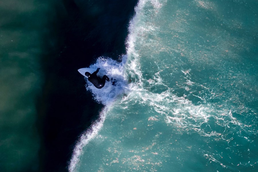 shades of surfing by scott fisher, view of surfer overhead using a drone