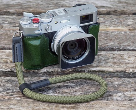 Fujifilm X100VI with half-case, rope strap, hood and thumb grip.