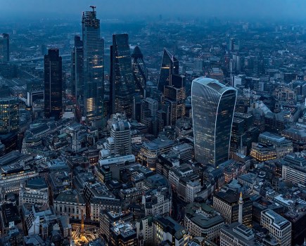 aerial photography of london skyscrapers at night with lights on