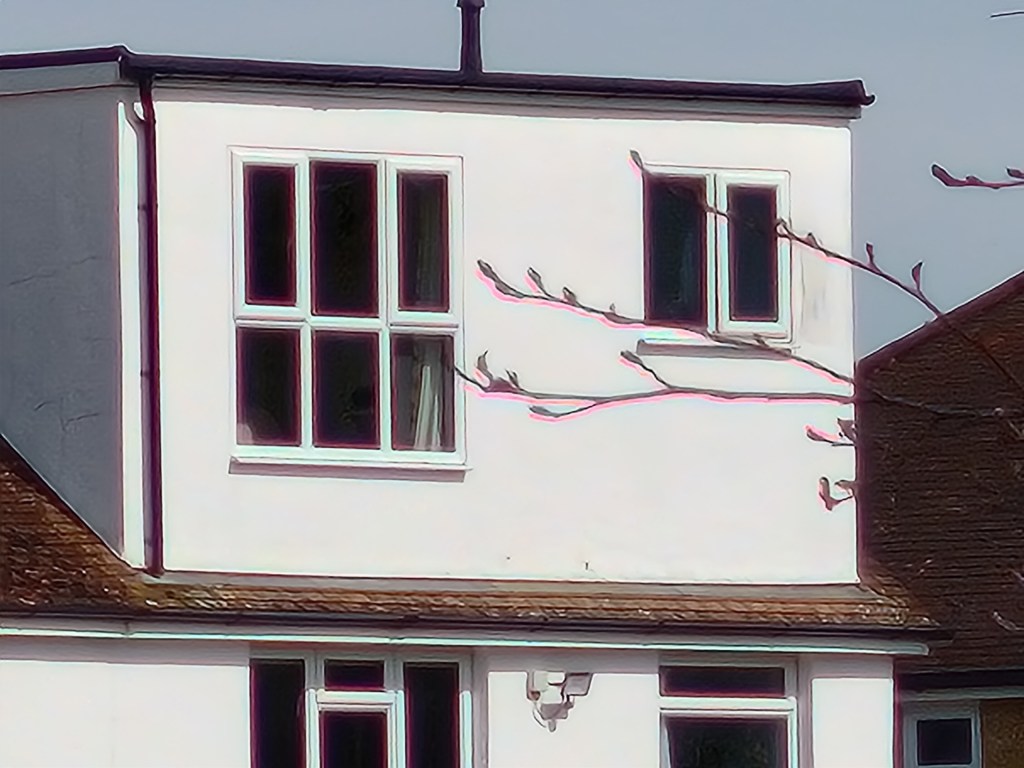 30x zoom on white building across the pond