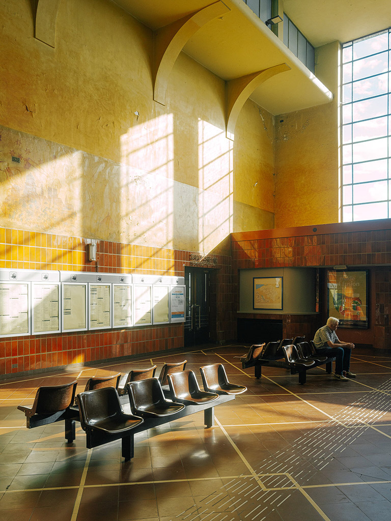 interior of public train station with golden light coming through a window