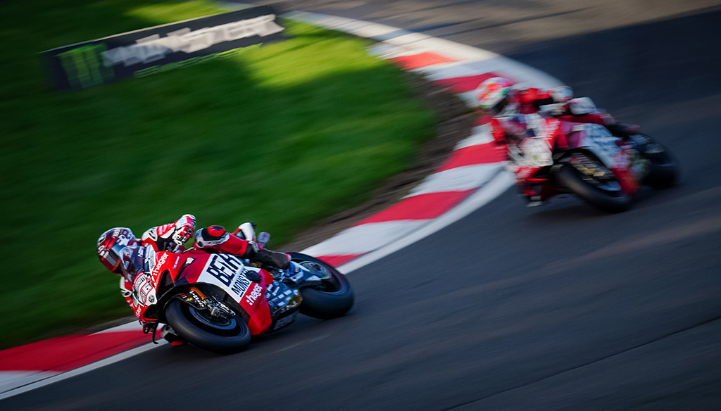 motorbike race one bike in front with another shortly behind with motion blur