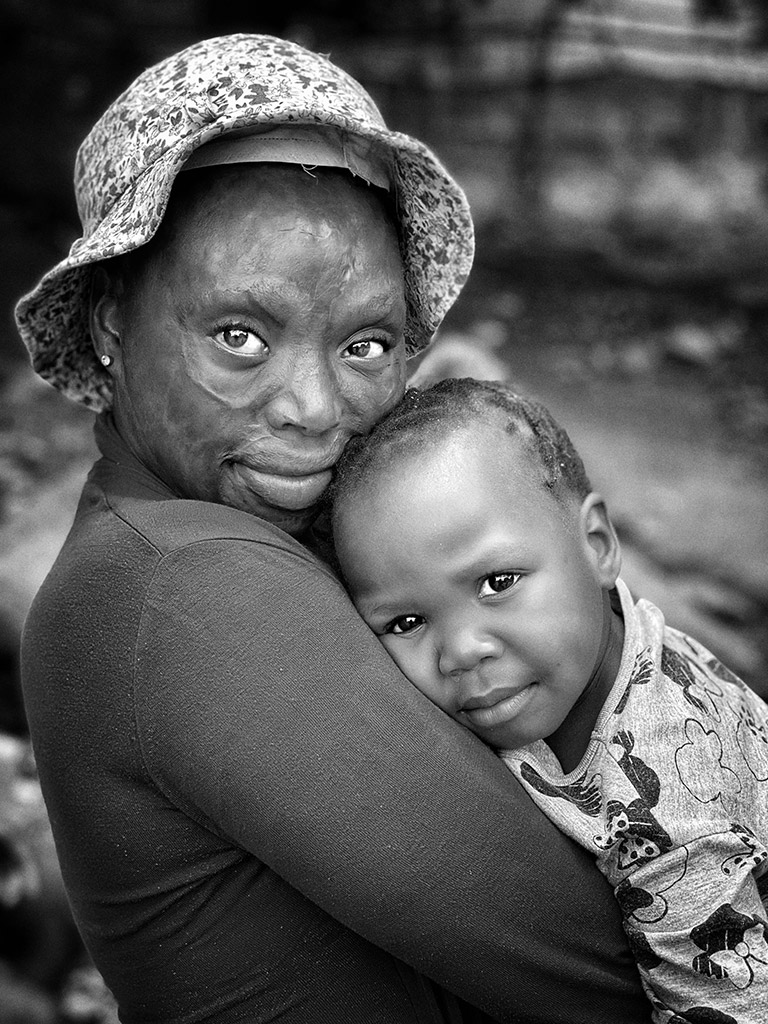 portrait of a woman holding young child