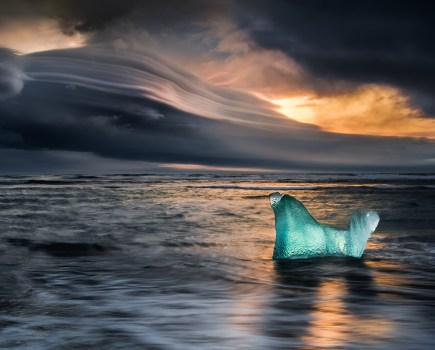 ice block in water landscapes overlooking moody sunset