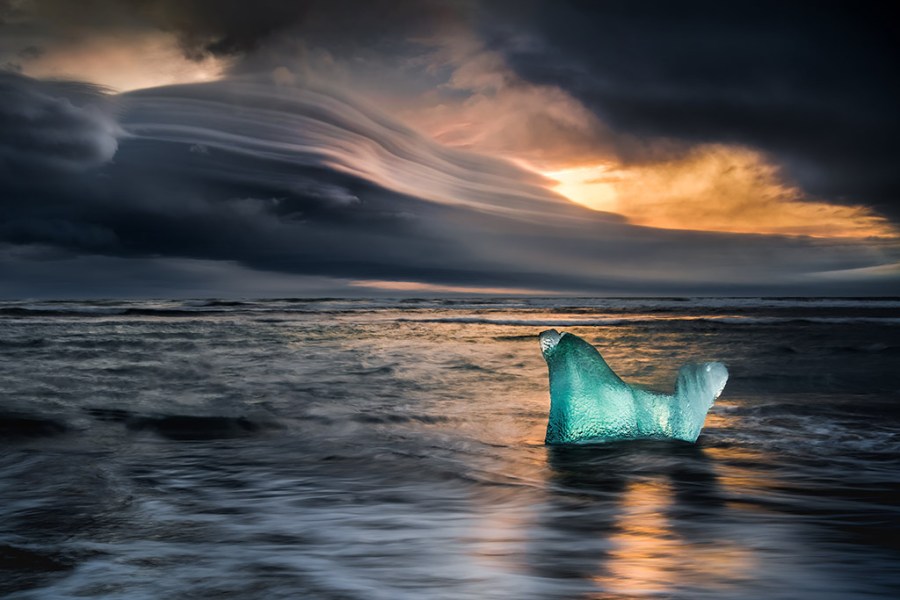 ice block in water landscapes overlooking moody sunset