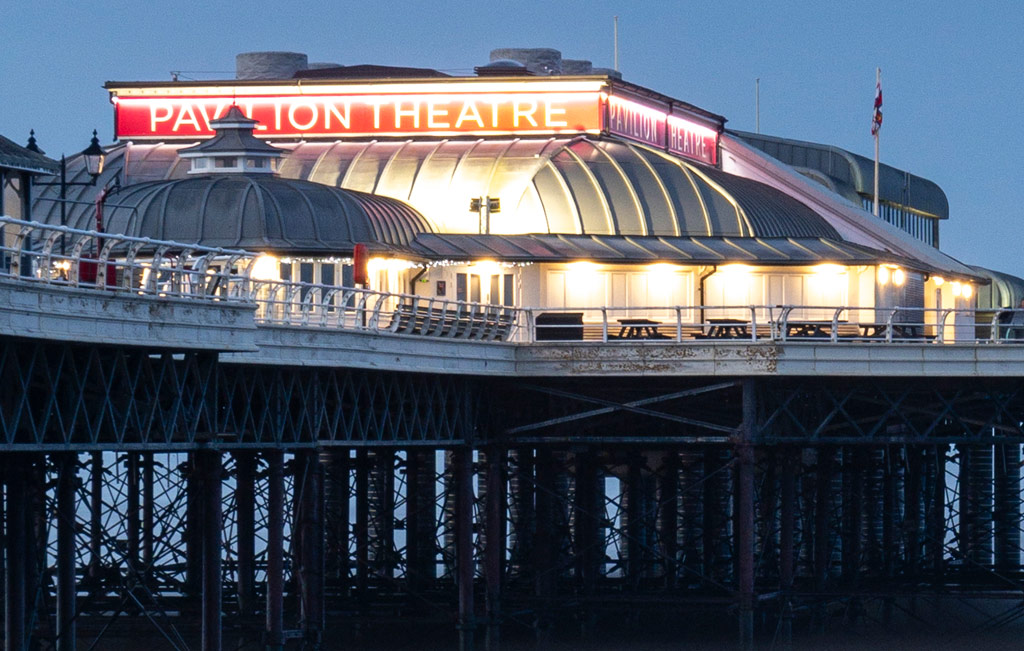 Seascape after sunset with a pier and a theatre