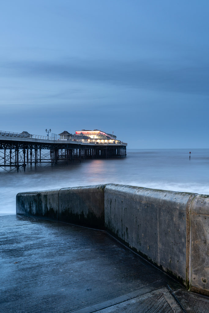 Seascape after sunset with a pier and a theatre