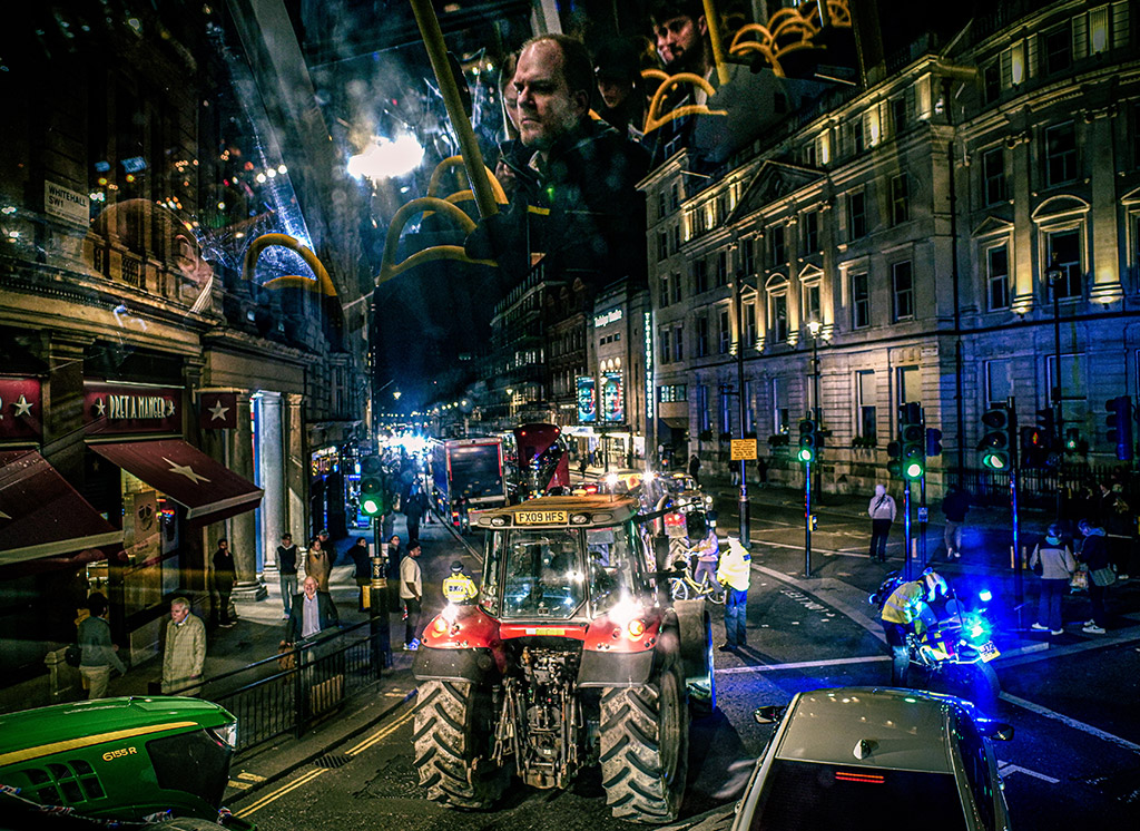 composite of city road scene at night with tractor and bus image layered