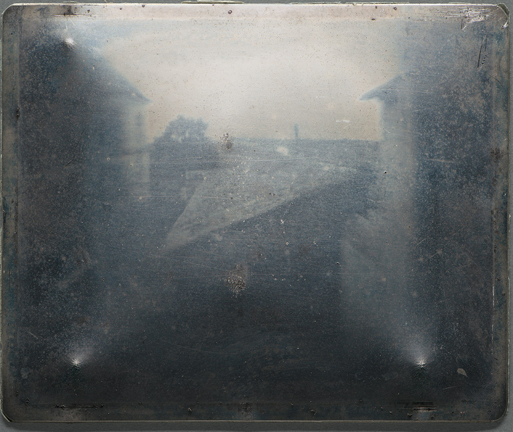 View from the window at Le Gras. The earliest surviving 'point de vue'. Heliograph on a pewter plate, made by Nicéphore Niépce, c.1827.  Gernsheim Collection, at the HRHRC, University of Texas, Austin. 