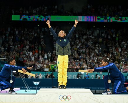 TOPSHOT - (LtoR) US' Simone Biles (silver), Brazil's Rebeca Andrade (gold) and US' Jordan Chiles (bronze) pose during the podium ceremony for the artistic gymnastics women's floor exercise event of the Paris 2024 Olympic Games at the Bercy Arena in Paris, on August 5, 2024.