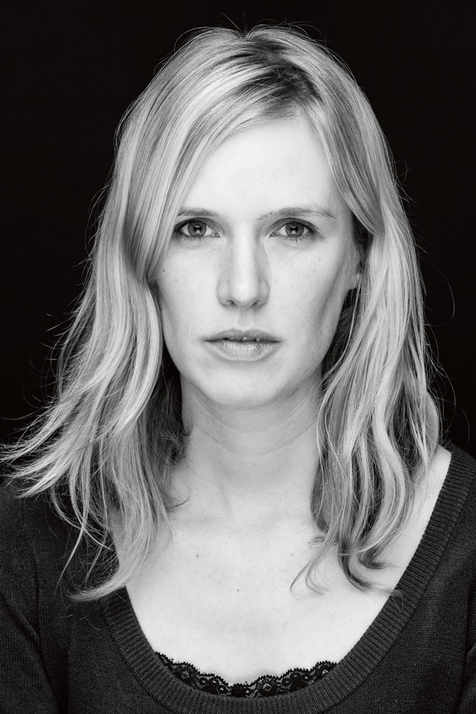 Black and white studio portrait of a woman, shot with flashlight and softbox