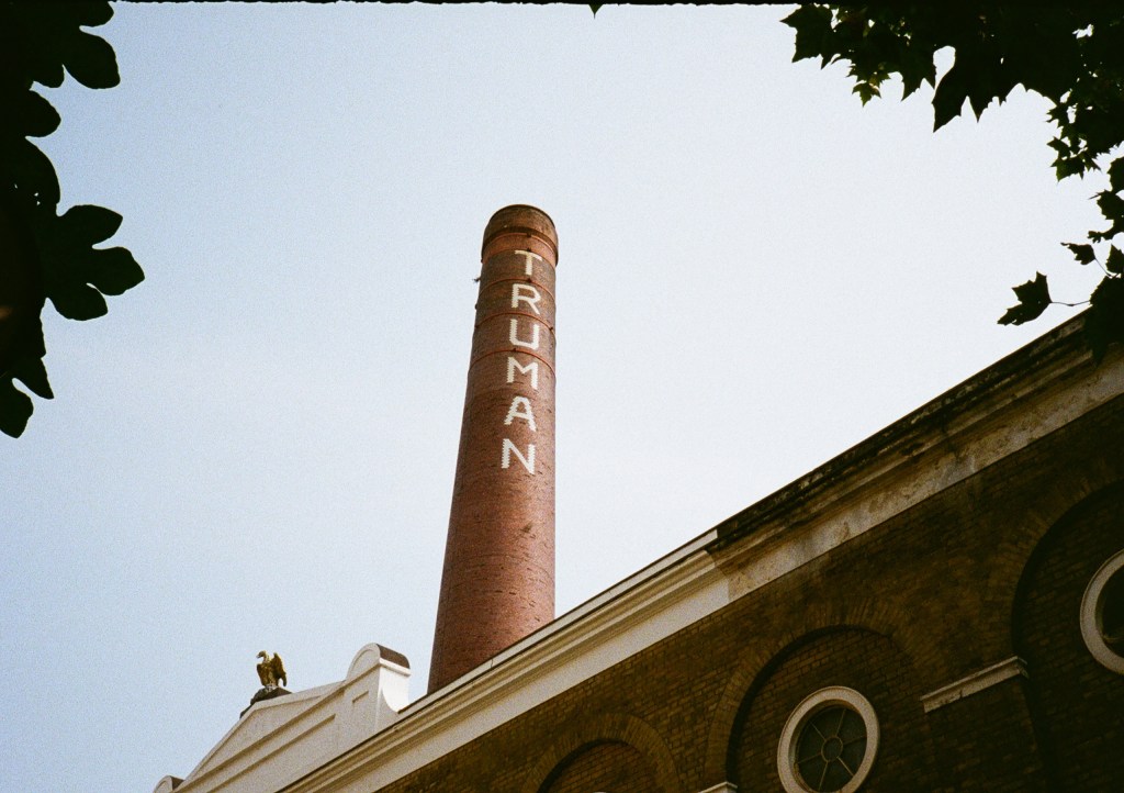 looking up at chimney that has the word Truman written down it taken n pentax 17