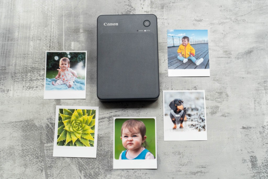 The Selphy QX20 printer surrounded by a set of square prints