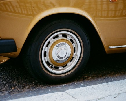 close up photo of an old yellow Rolls-Royce wheel