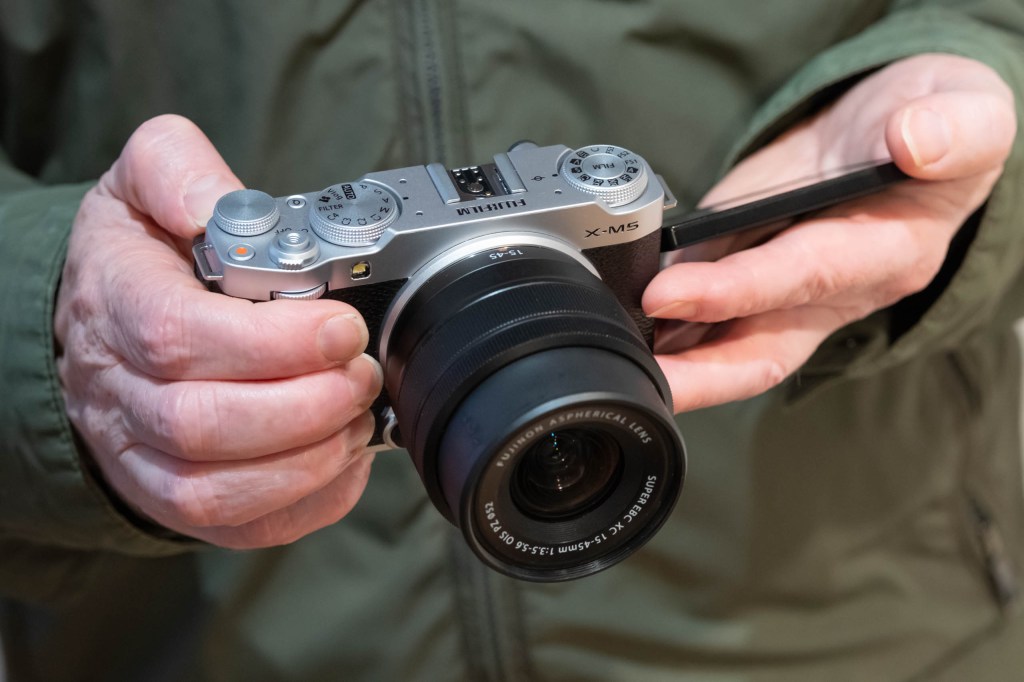 Fujifilm X-M5 in-hand with screen folded out