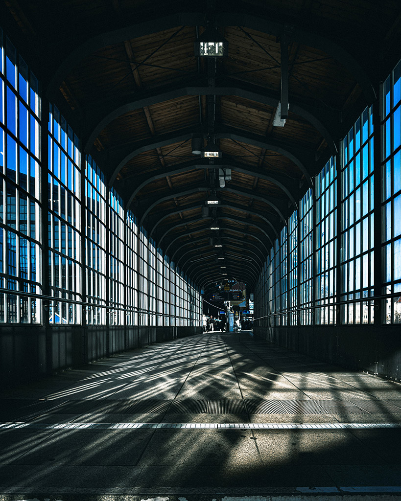 architecture of a train station with bright sunlight seeping through window