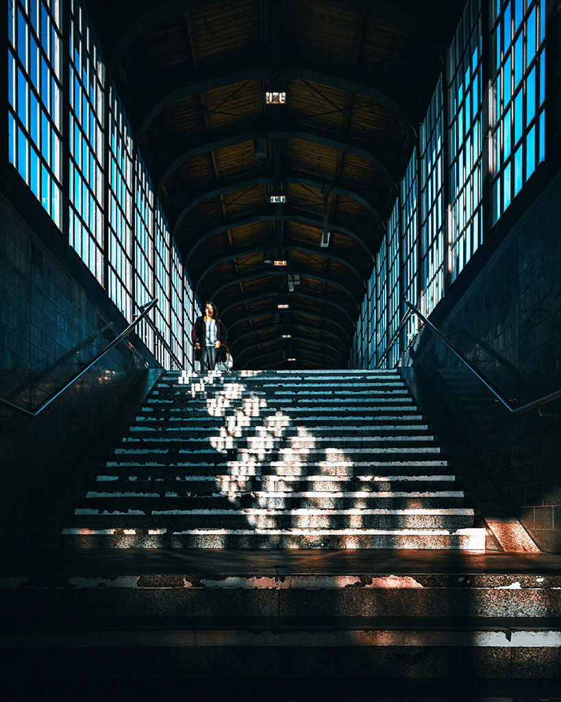 architecture of a train station with bright sunlight seeping through window