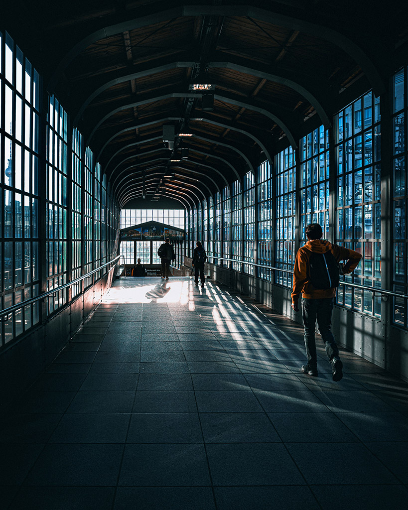 architecture of a train station with bright sunlight seeping through window