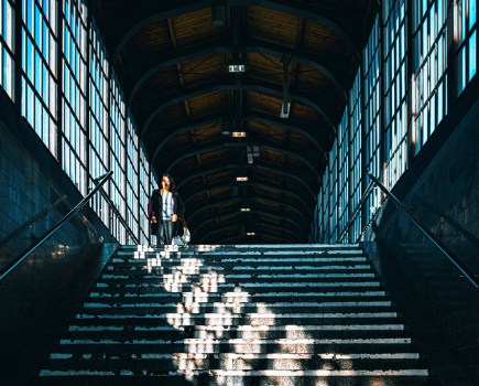 architecture of a train station with bright sunlight seeping through window