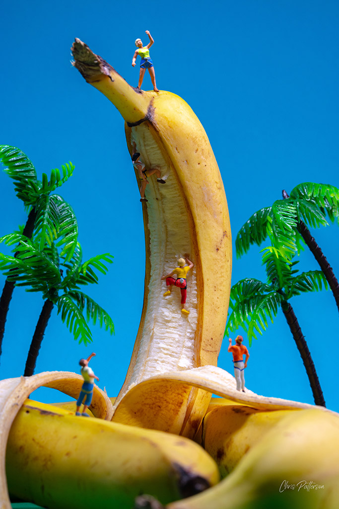 peeled banana used as a climbing wall for tiny miniature figurines