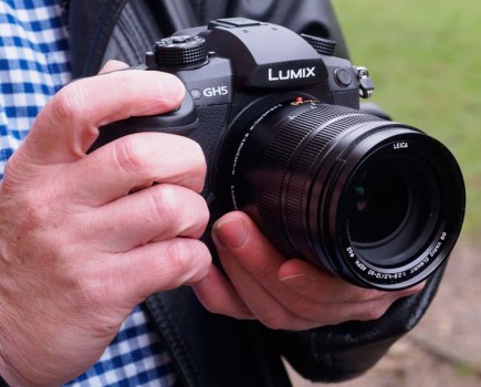 Hands holding Panasonic Lumix Gh5 mirrorless camera