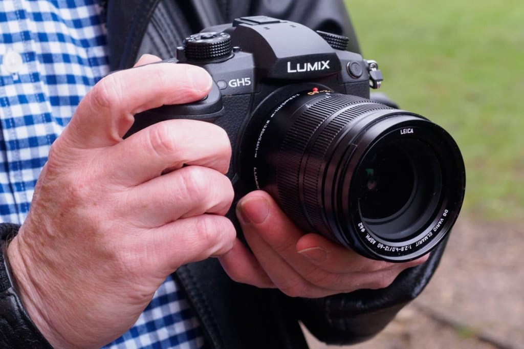 Hands holding Panasonic Lumix Gh5 mirrorless camera