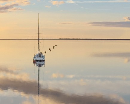 peaceful landscape scene of a boat and still water after storm