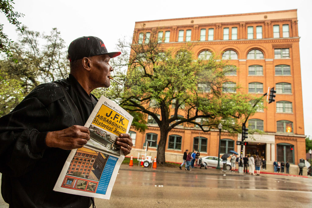 Dallas, man with a newspaper about the J.F.K. shootings