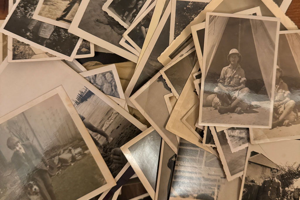 Old photographs spread on a table, family archive