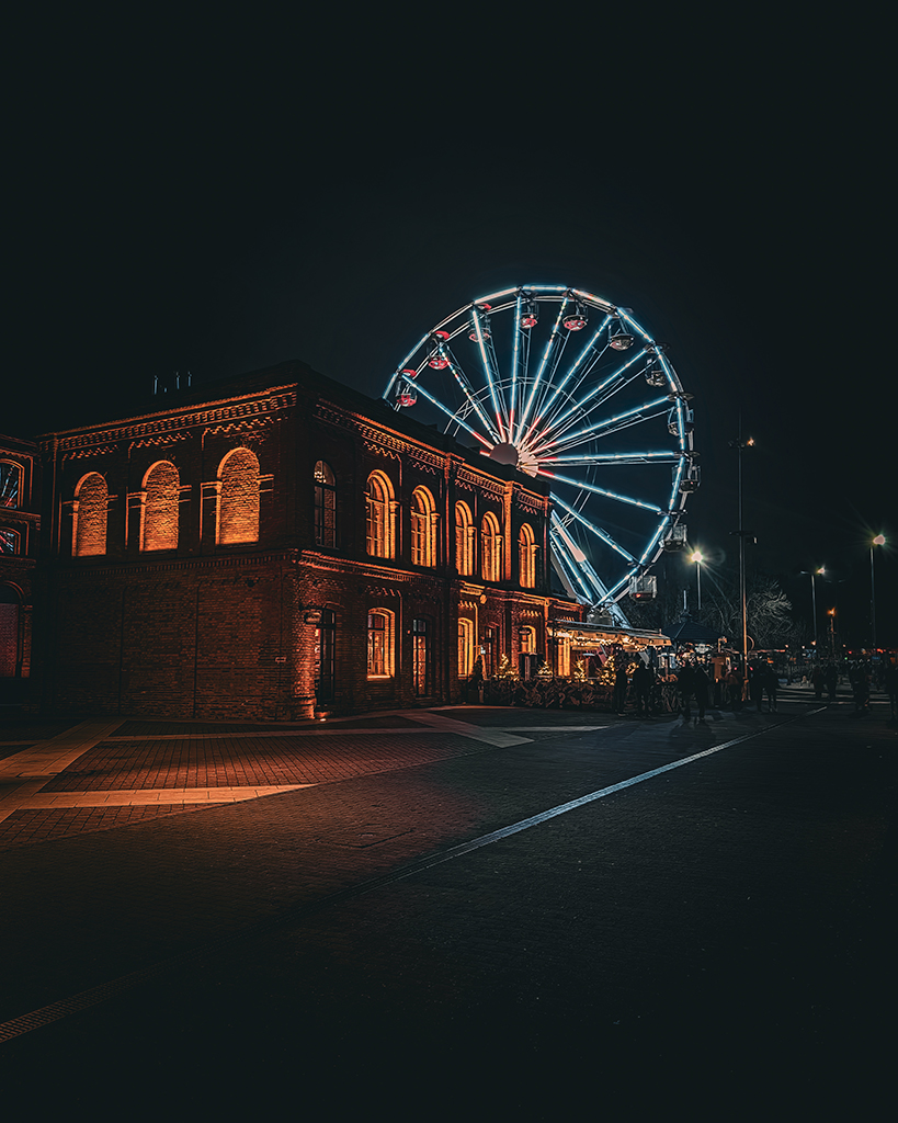 ferris wheel lit up at night in poland