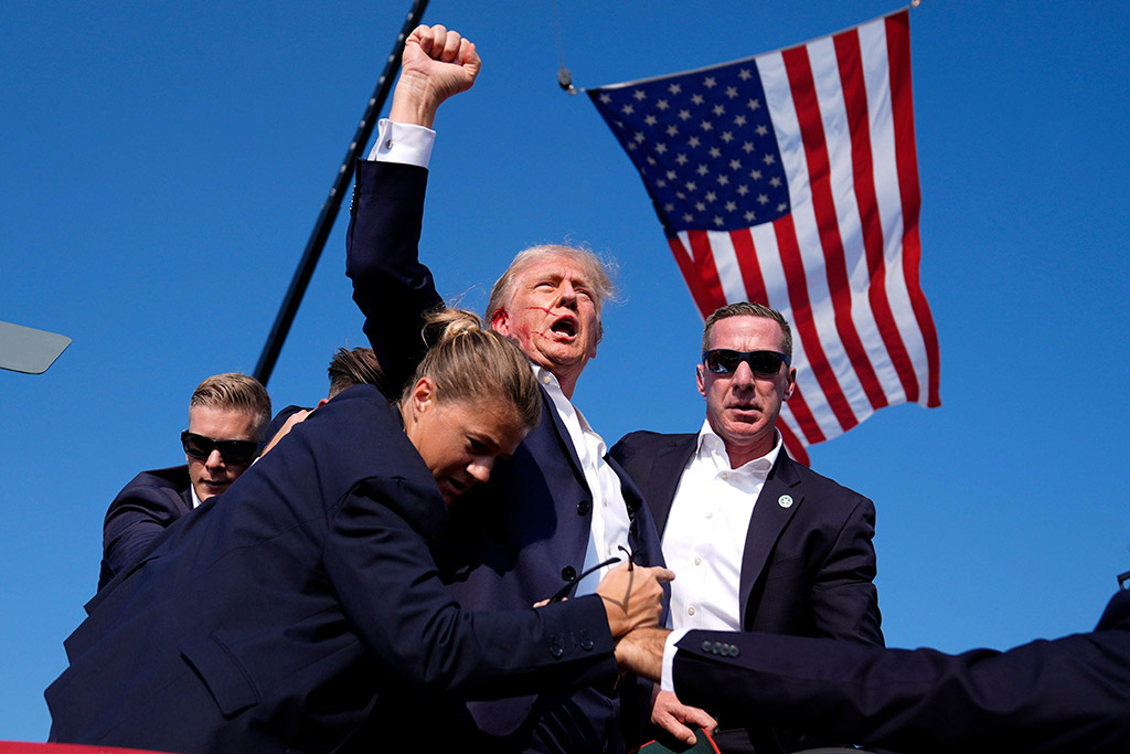 Republican presidential candidate former President Donald Trump is surrounded by U.S. Secret Service agents at a campaign rally, Saturday, July 113, 2024, in Butler. ©AP Photo/Evan Vucci