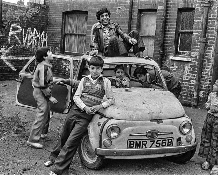 image of boys posing around old car by david hoffman