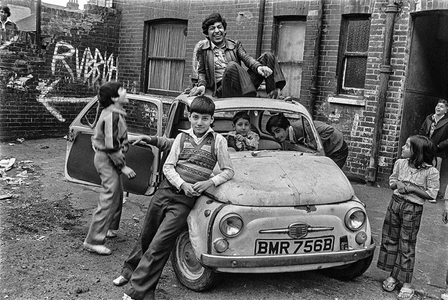 image of boys posing around old car by david hoffman