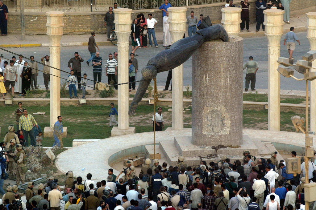 Iraqis watch a statue of Saddam Hussein fall by Patrick Baz