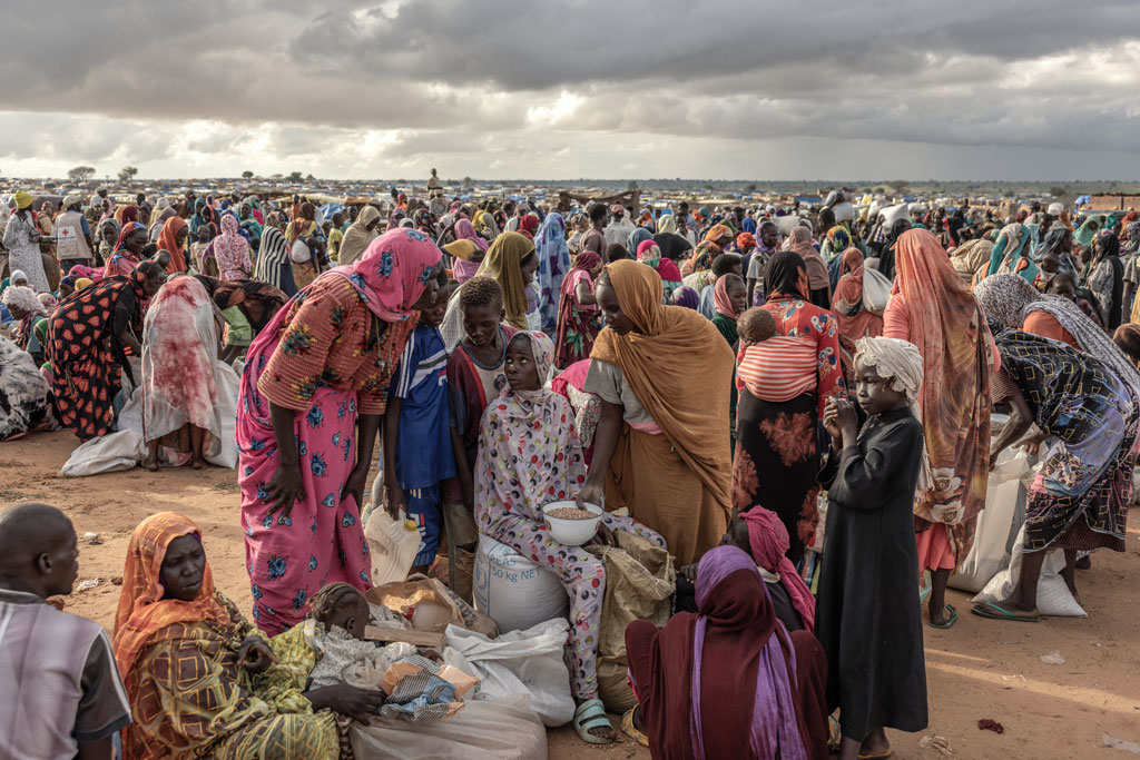 People displaced from Darfur by the Sudan war gather for a monthly food distribution, in Adre, eastern Chad, August 9, 2024.