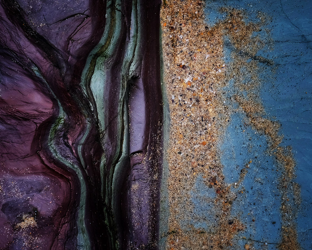 close-up photo of a rock showing two colours left purple and right blue