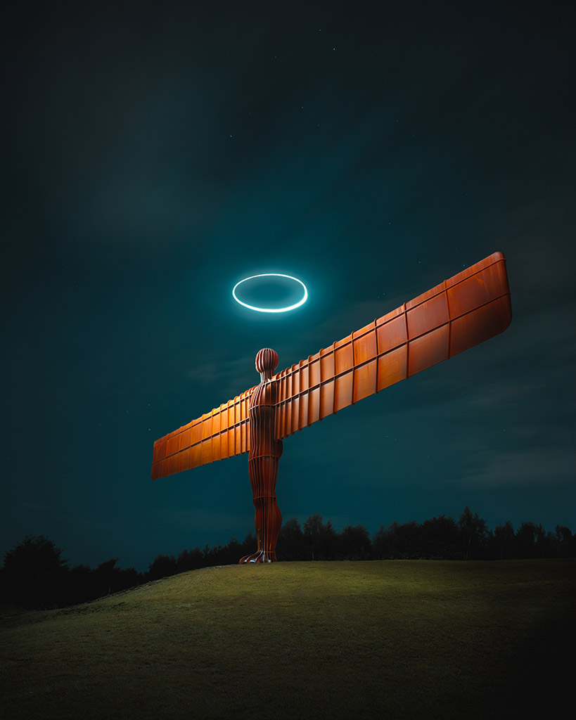 angel of the north statue at night with drone light making a halo above