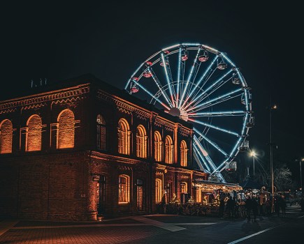 ferris wheel lit up at night in poland