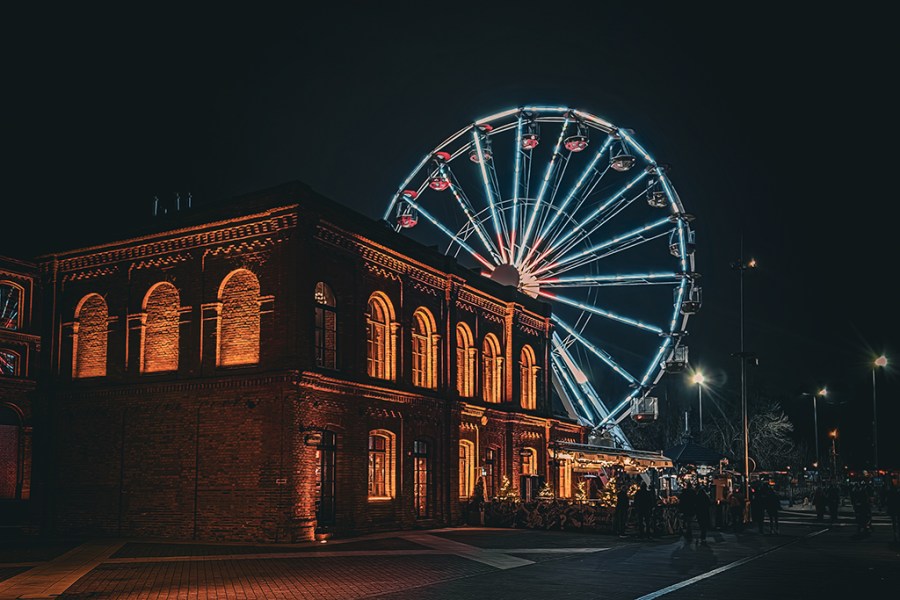 ferris wheel lit up at night in poland