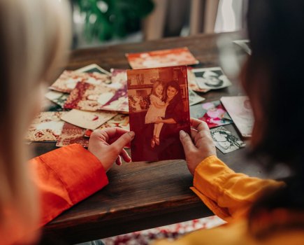 Mother and daughter looking at family photos