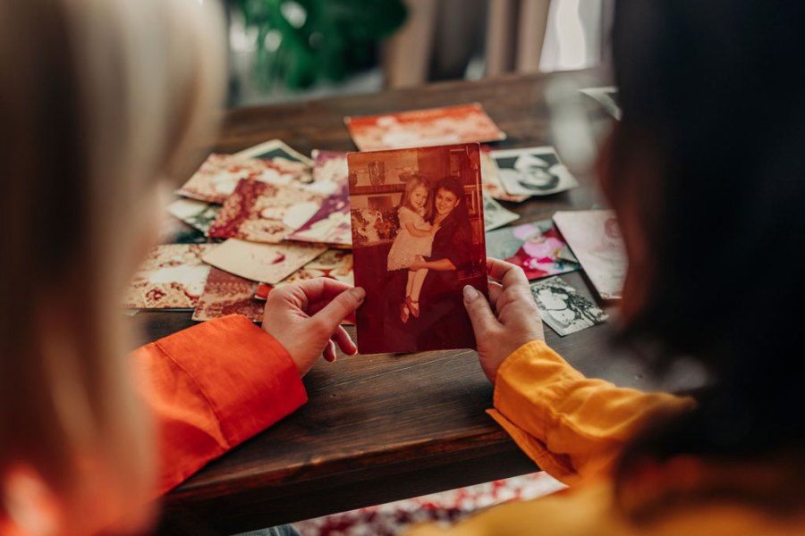 Mother and daughter looking at family photos