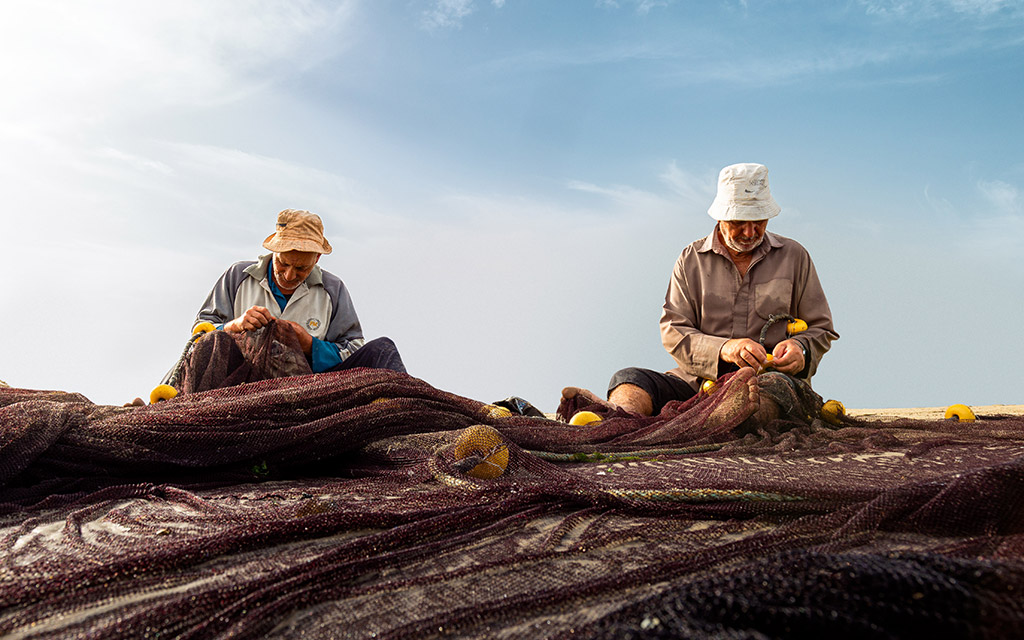 fishermen fixing their fishing nets 