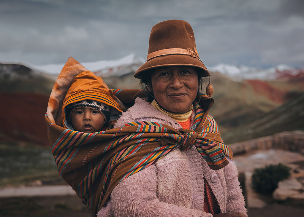 portrait of a Peruvian woman witha  young child on her back