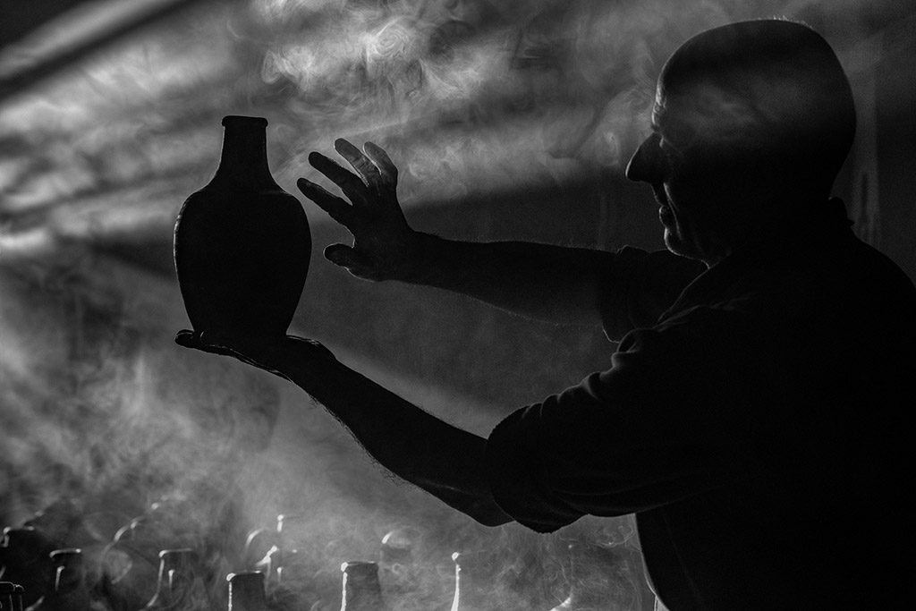 Turkish potter silhouette holding a pot