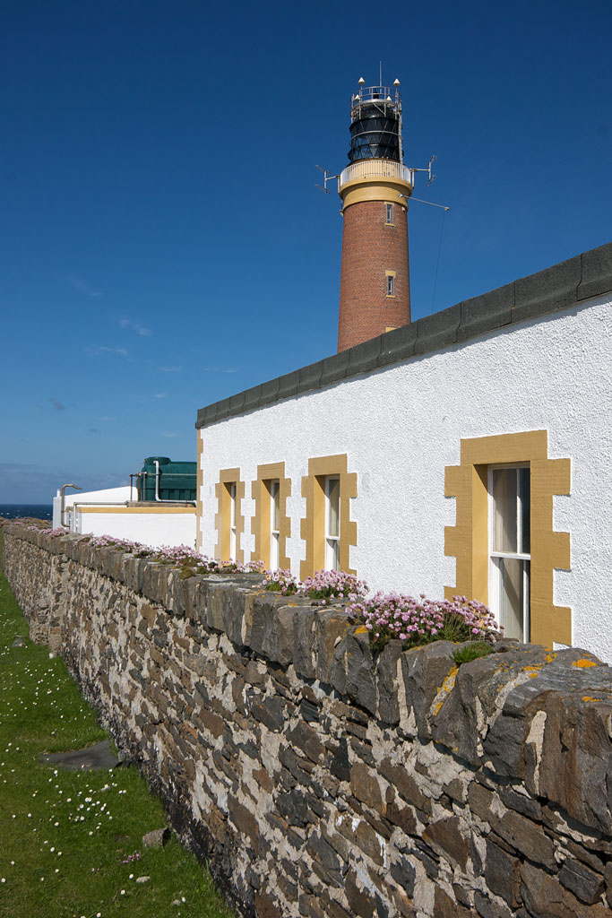 a lighthouse with a stone wall