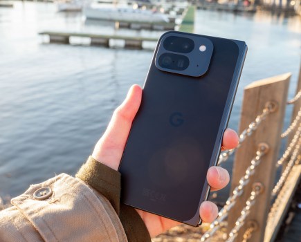 Google Pixel 9 Pro Fold in hand in front of a water landscape