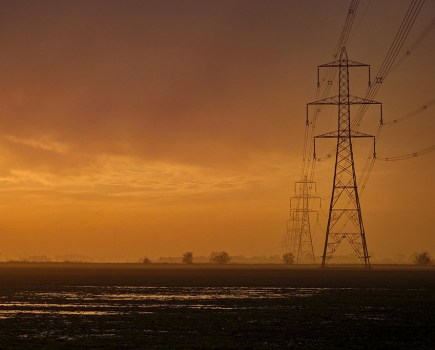 sunset landscape with electric pylons to the right