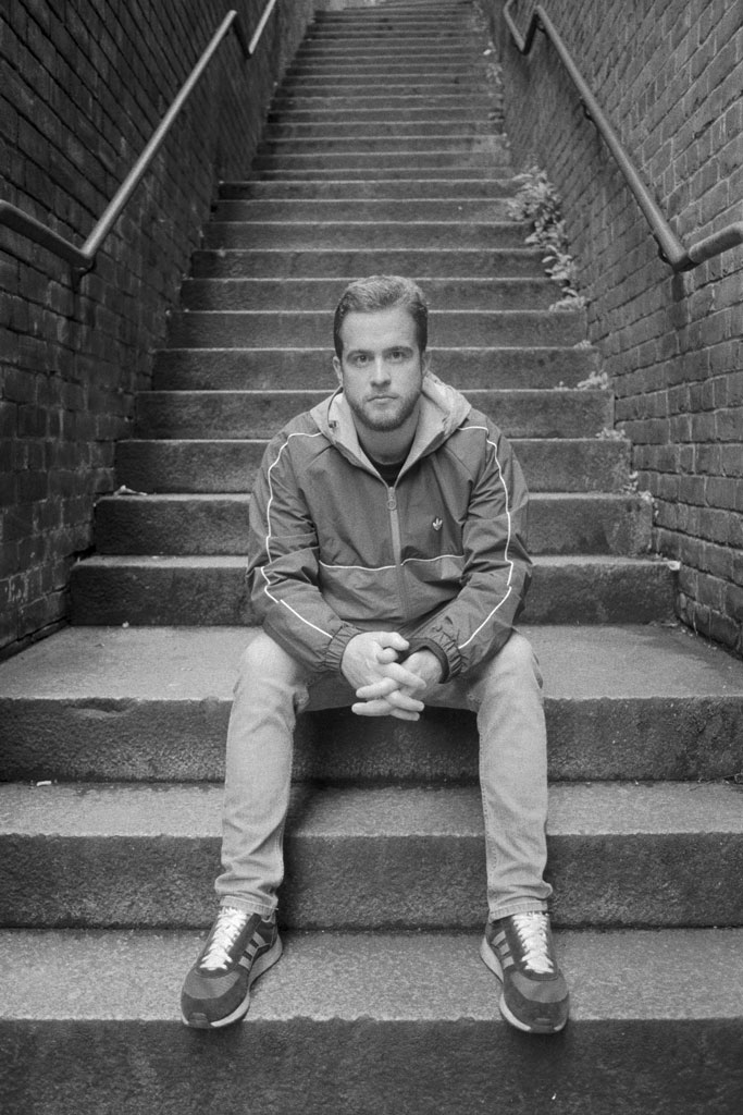 Nikon F2AS sample image, portrait of a man sitting on the stairs outdoors