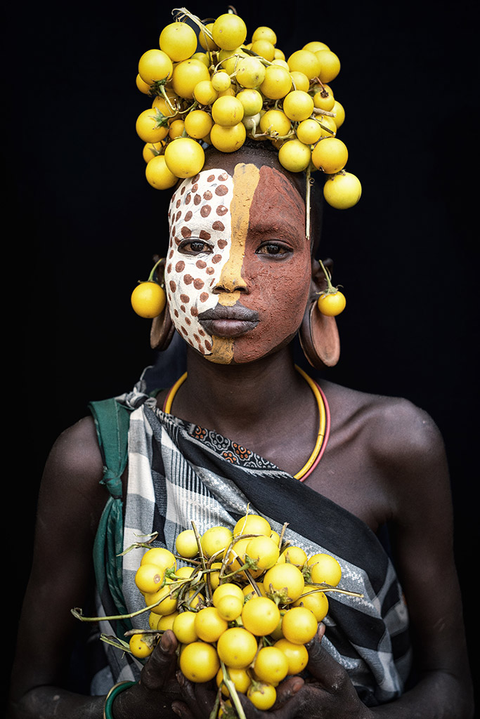 portrait of Suri tribe member with yellow headpiece